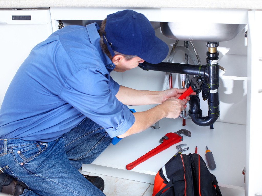 Residential plumbing repair beneath a sink